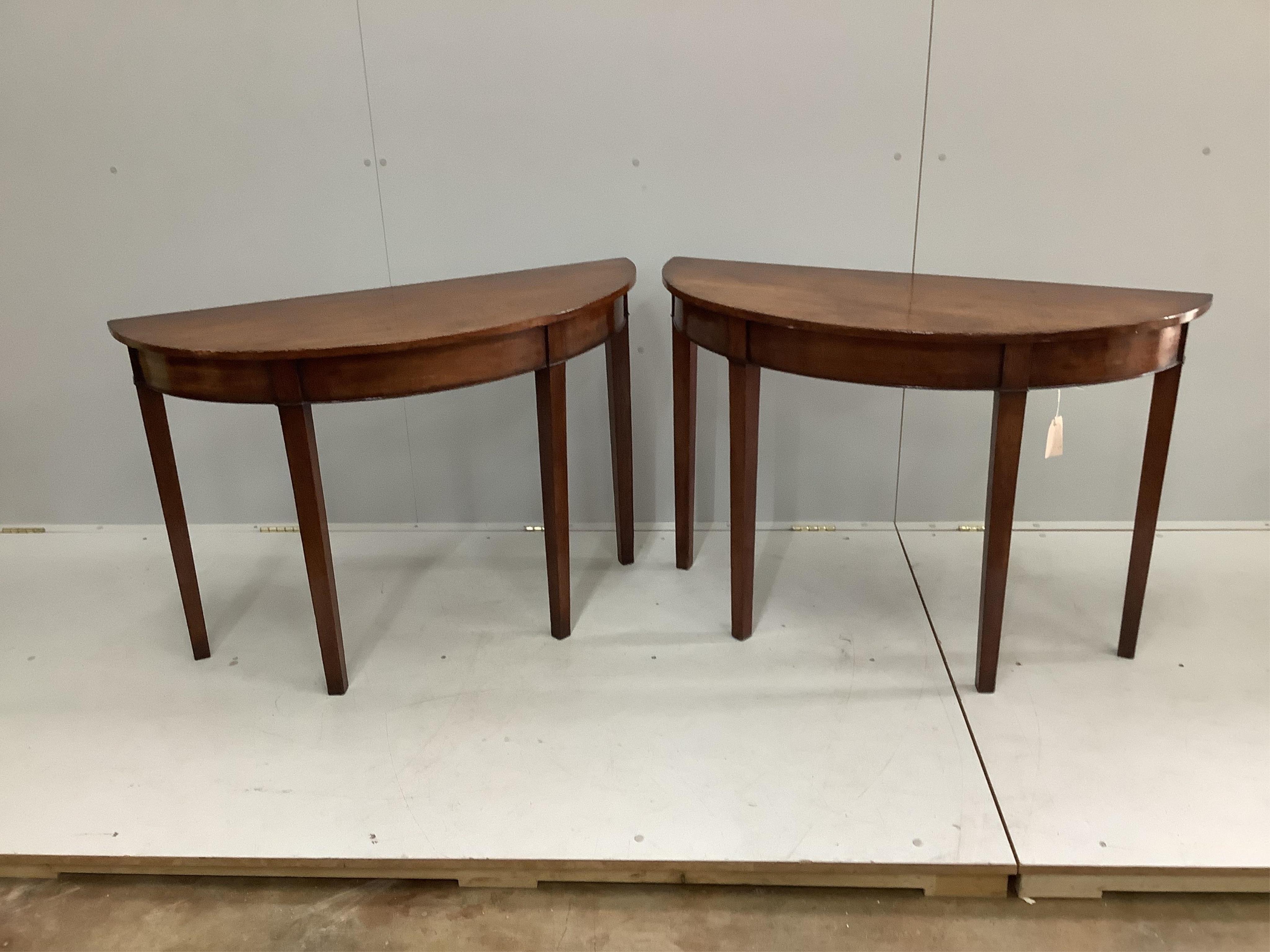 A pair of George III style mahogany D shaped console tables, width 104cm, depth 40cm, height 72cm. Condition - fair